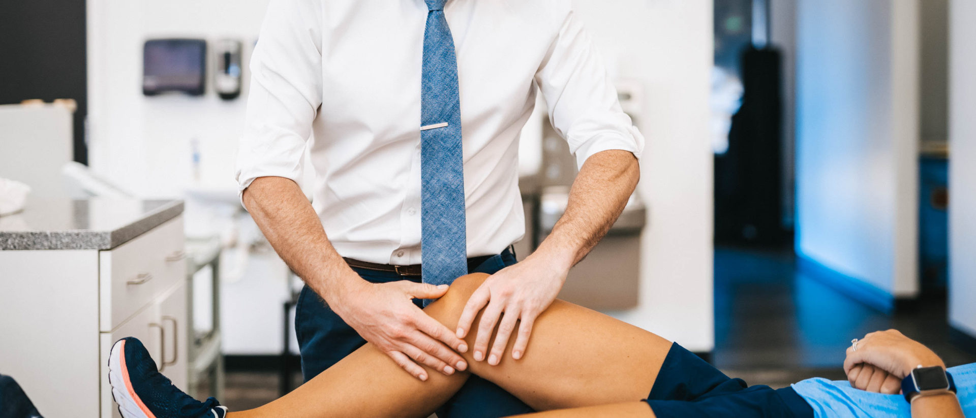 Physical therapist treating knee pain
