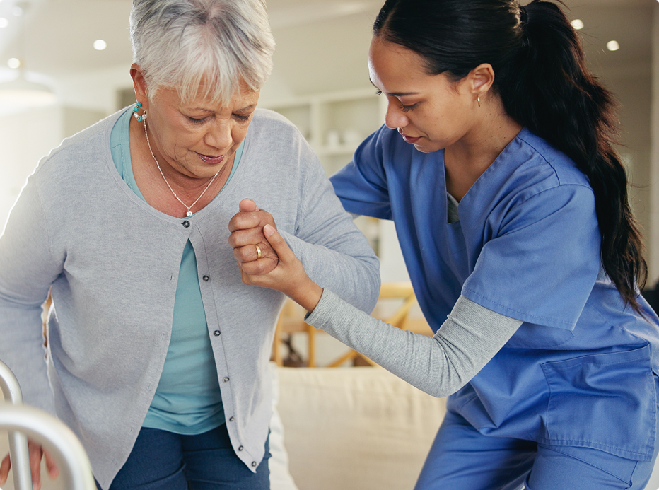 physician helping elder patient recover balance