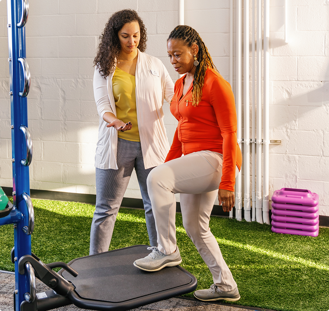 PT Solutions clinician guiding a patient through strengthening exercises